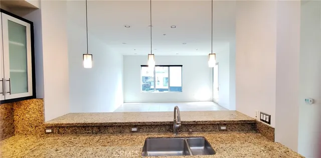a view of kitchen with refrigerator and window
