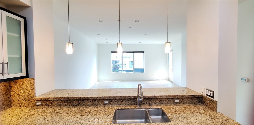 21 Gramercy, Unit 307 Irvine, CA 92612 - Photo 10 of 65 a bathroom with a granite countertop sink and a mirror