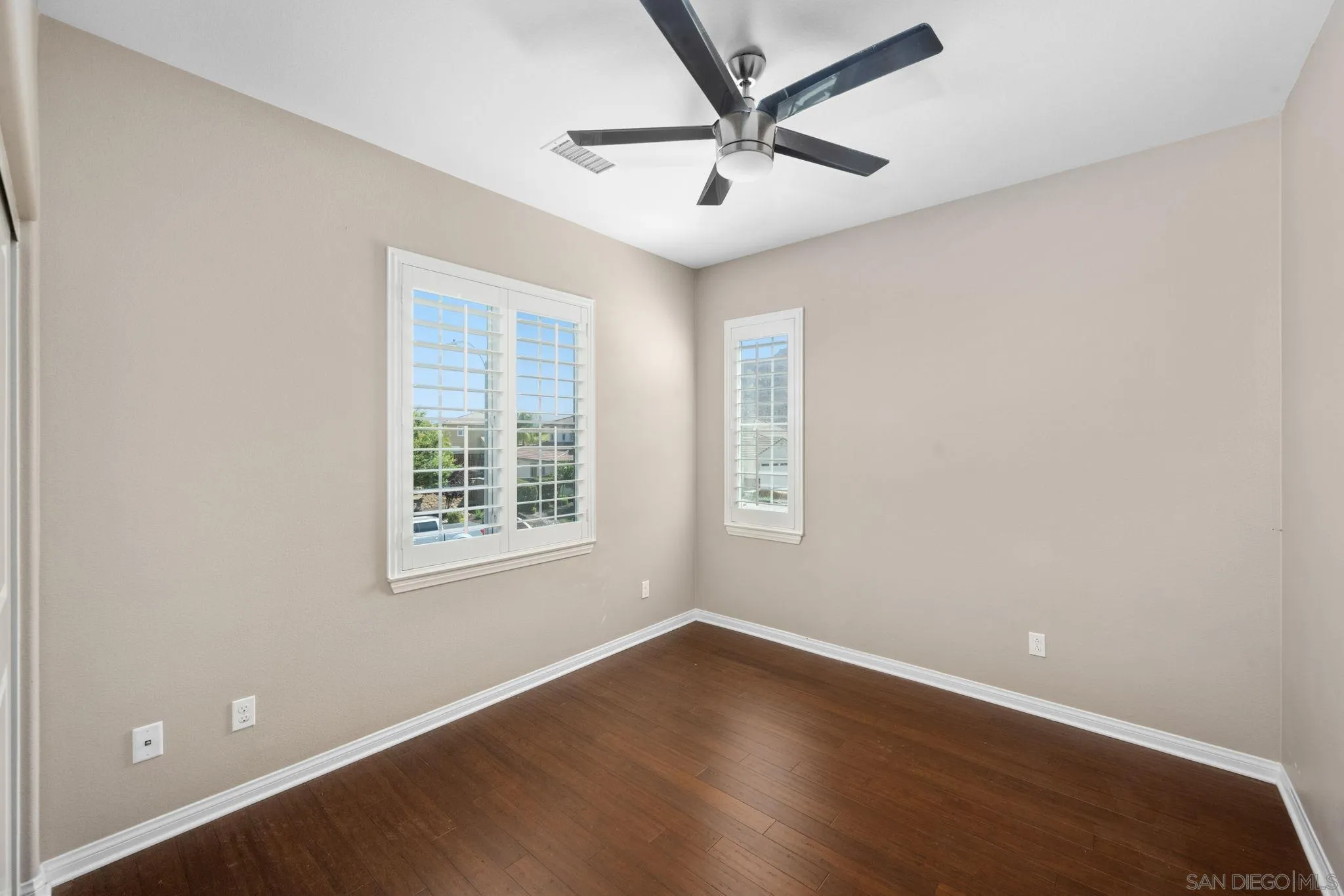 29885 Loy Drive Menifee, CA 92585 - Photo 13 of 75 an empty room with wooden floor and windows