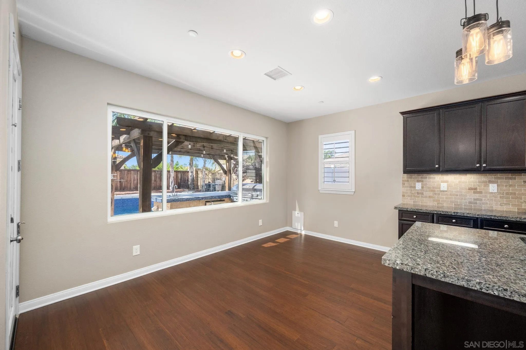 29885 Loy Drive Menifee, CA 92585 - Photo 24 of 75 a kitchen with granite countertop wooden cabinets and a stove