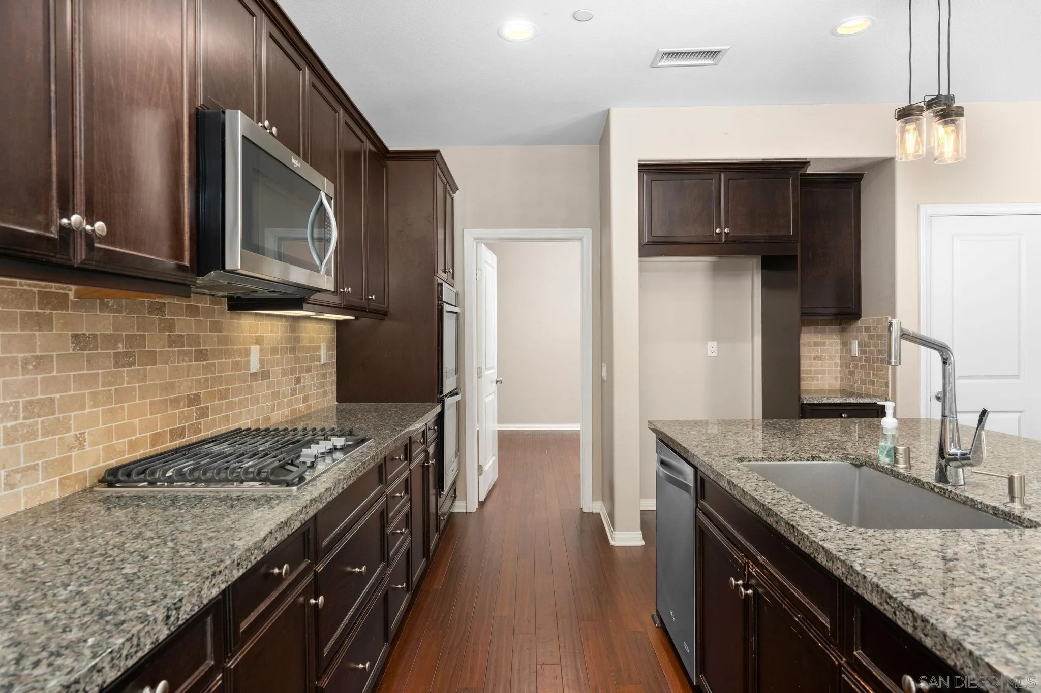 29885 Loy Drive Menifee, CA 92585 - Photo 27 of 75 a kitchen with kitchen island granite countertop a sink stove and refrigerator