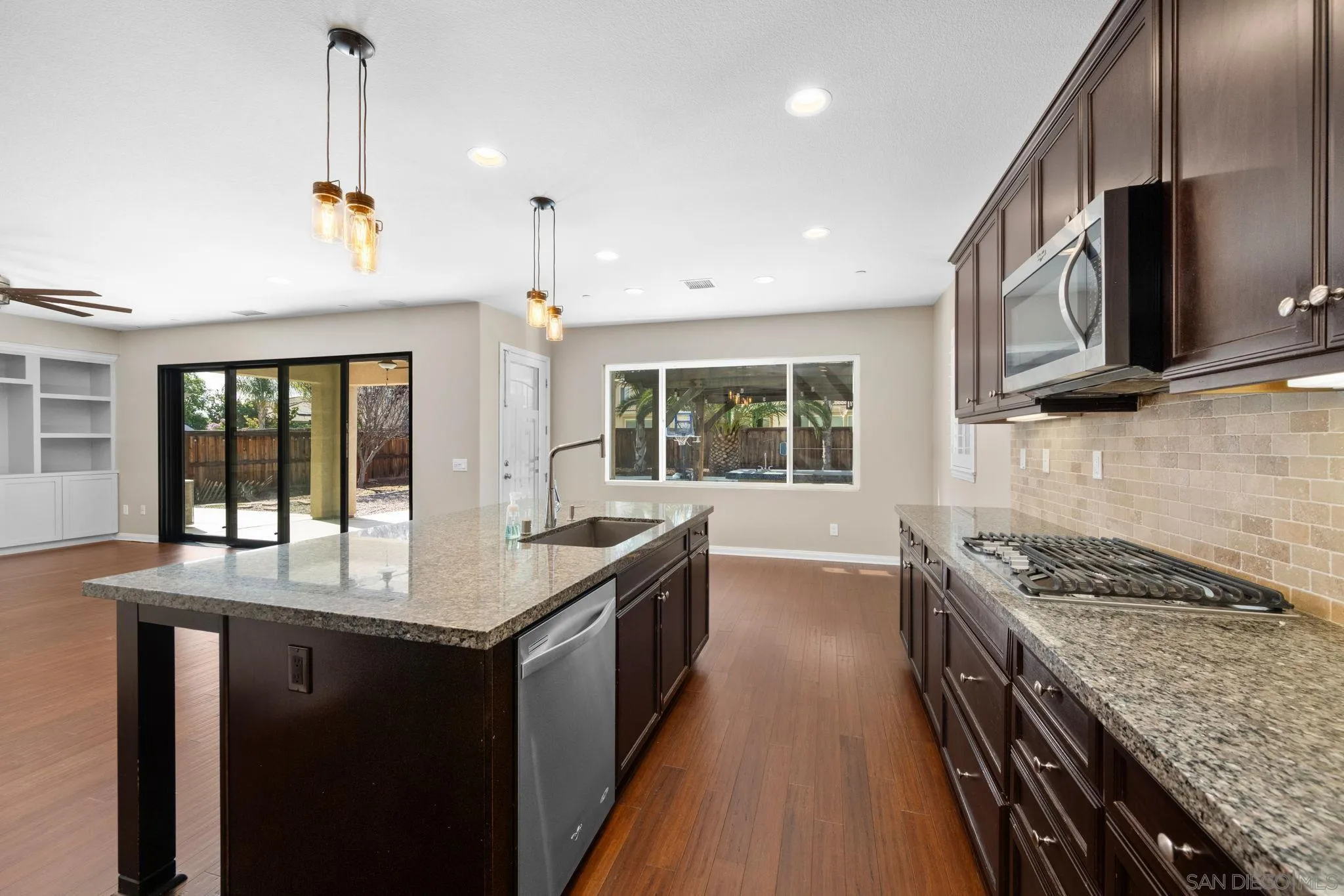 29885 Loy Drive Menifee, CA 92585 - Photo 28 of 75 a kitchen with granite countertop sink stove and cabinets