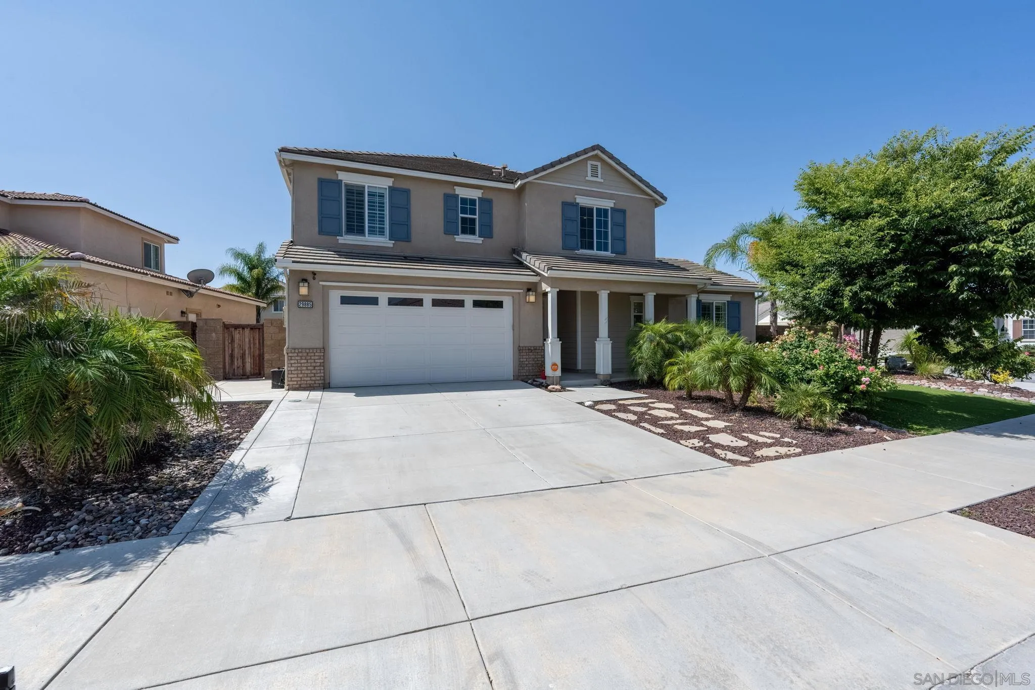 29885 Loy Drive Menifee, CA 92585 - Photo 37 of 75 a front view of a house with a yard and potted plants