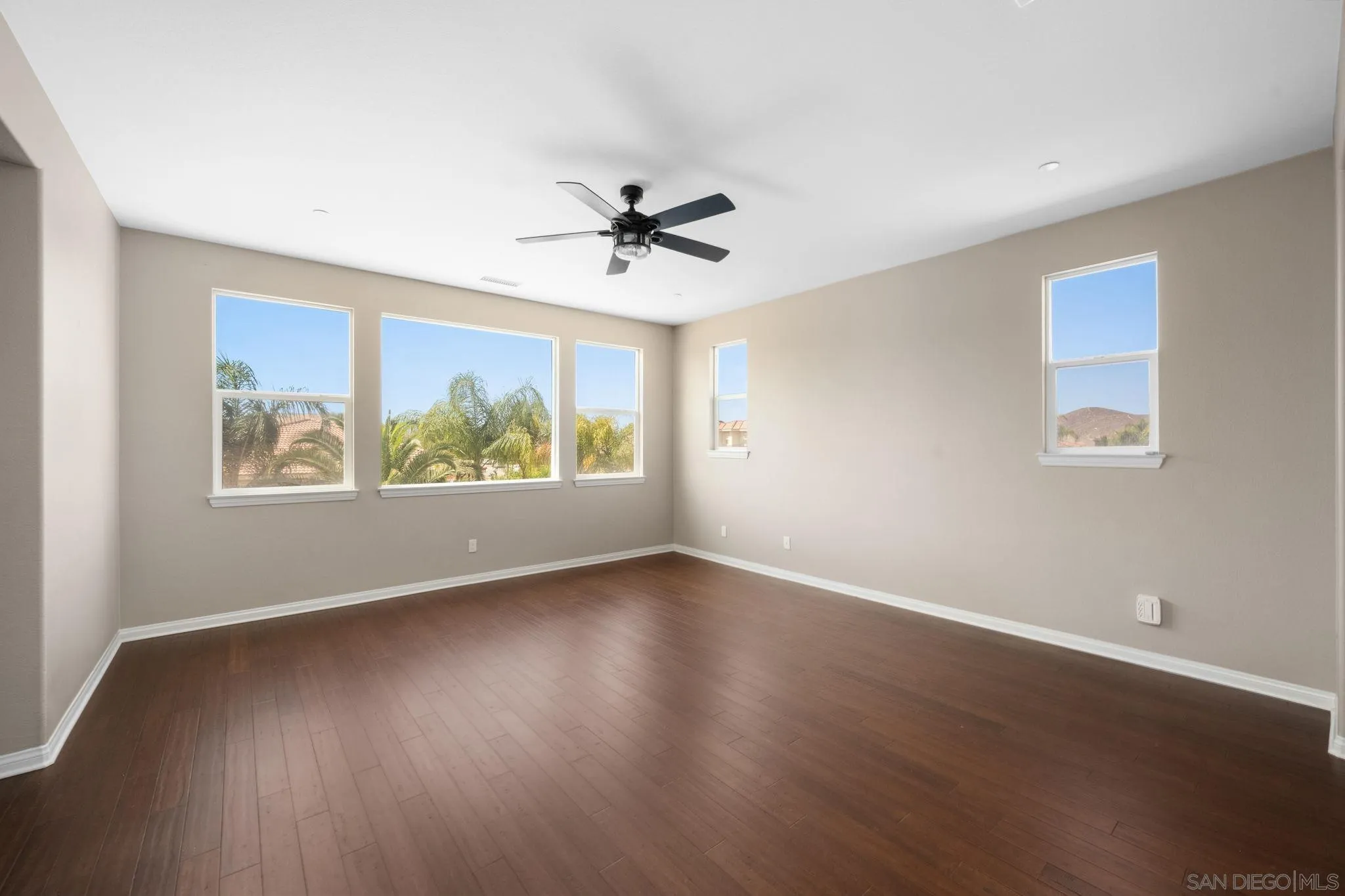 29885 Loy Drive Menifee, CA 92585 - Photo 4 of 75 a view of an empty room with window and wooden floor