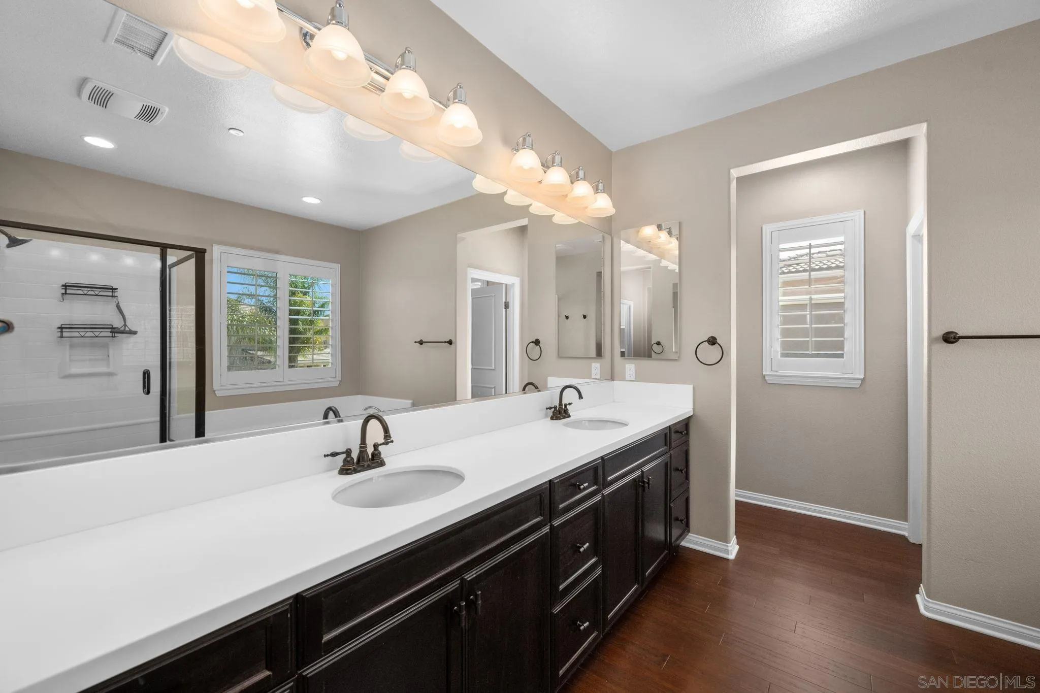 29885 Loy Drive Menifee, CA 92585 - Photo 7 of 75 a bathroom with a double vanity sink a mirror and a shower