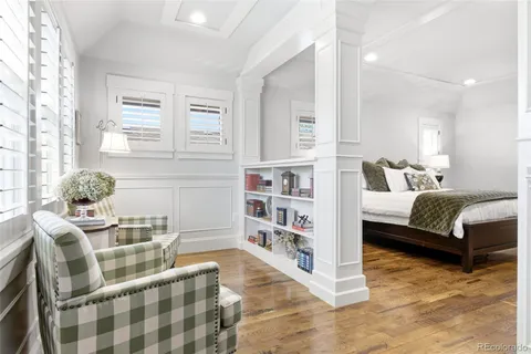 a bedroom with furniture and a book shelf