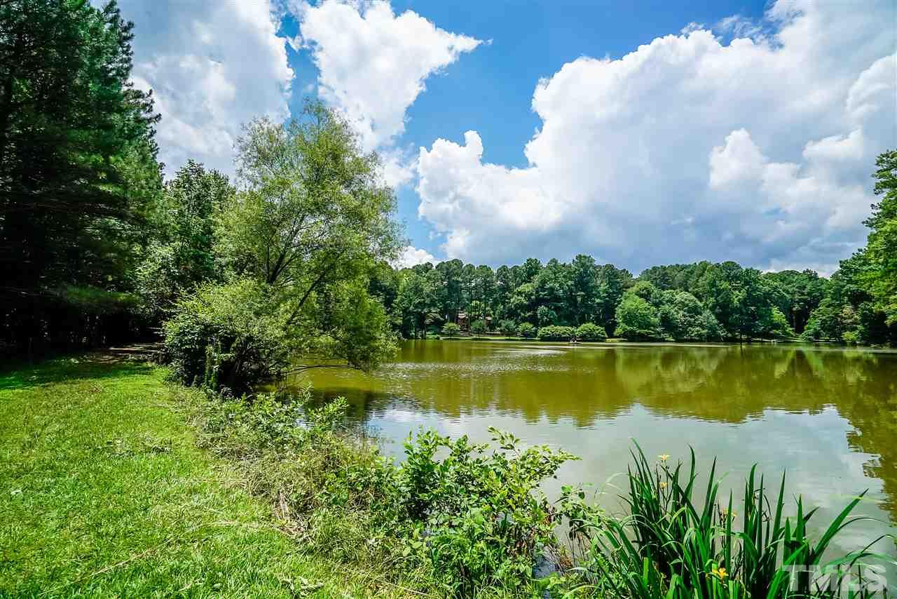 8636 Baybridge Wynd Raleigh, NC 27613 - Photo 2 of 25 a view of a lake with a big yard