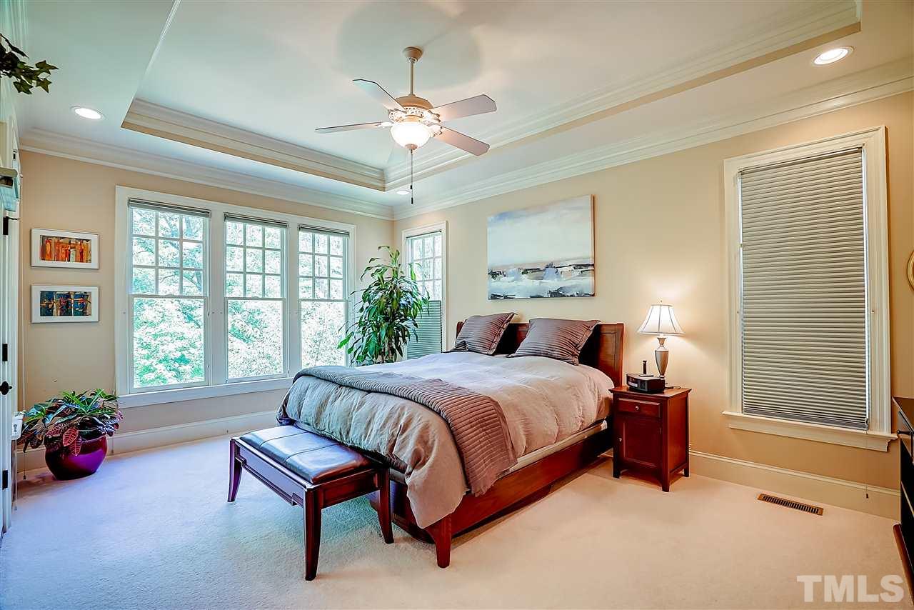 8636 Baybridge Wynd Raleigh, NC 27613 - Photo 11 of 25 a bedroom with a bed and a chandelier