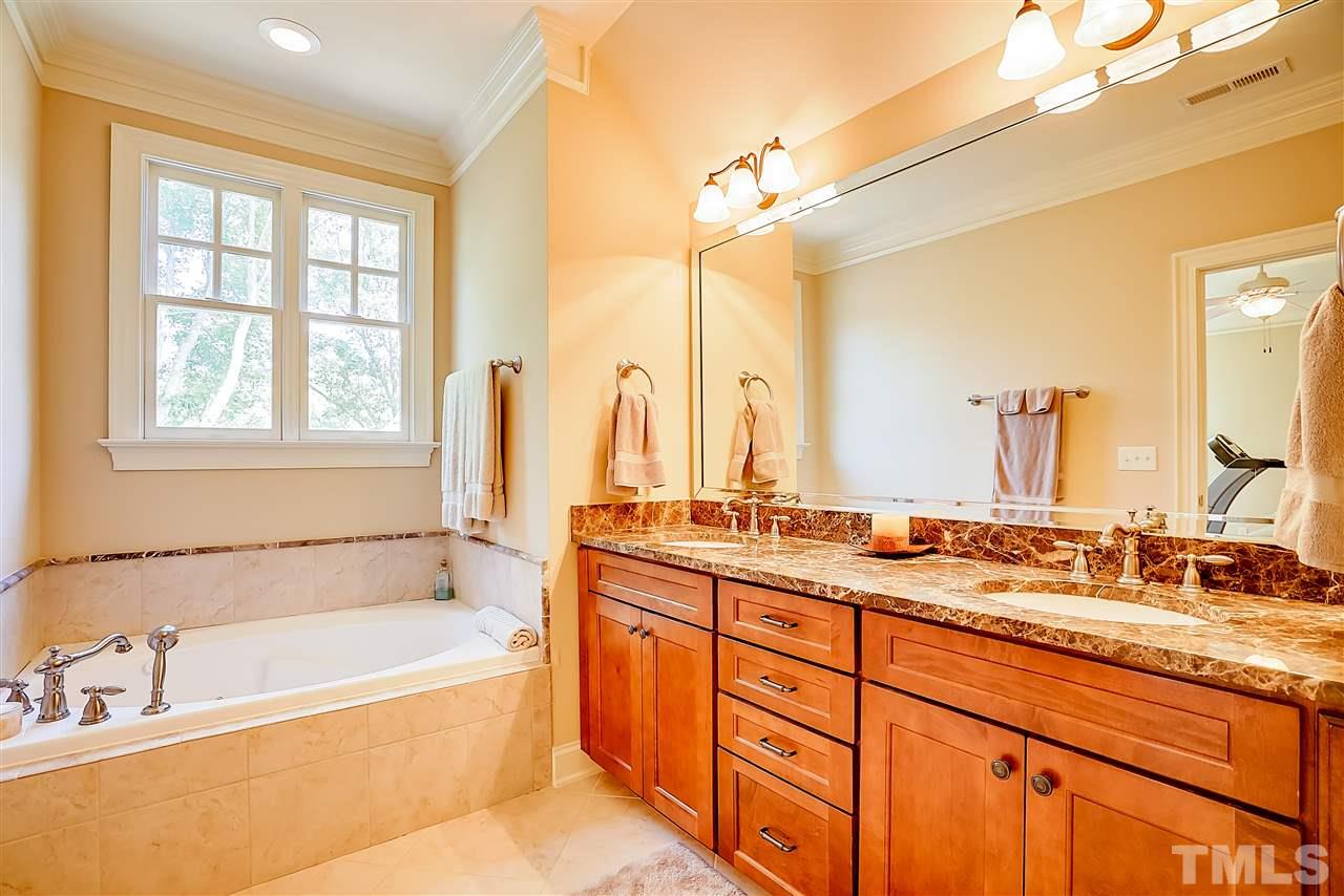 8636 Baybridge Wynd Raleigh, NC 27613 - Photo 15 of 25 a bathroom with a granite countertop sink and a bathtub
