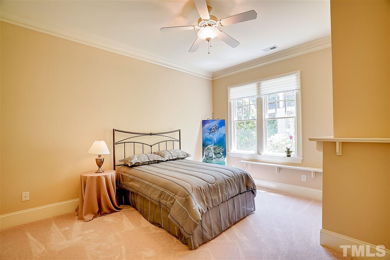 8636 Baybridge Wynd Raleigh, NC 27613 - Photo 16 of 25 a bedroom with a bed and a window
