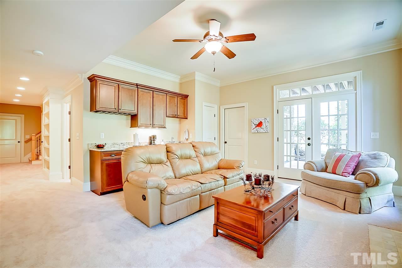 8636 Baybridge Wynd Raleigh, NC 27613 - Photo 19 of 25 a living room with furniture and a chandelier