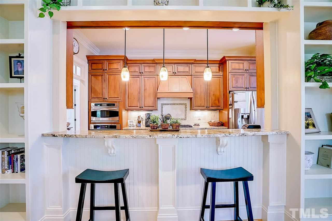 8636 Baybridge Wynd Raleigh, NC 27613 - Photo 7 of 25 a kitchen with stainless steel appliances a table and chairs in it