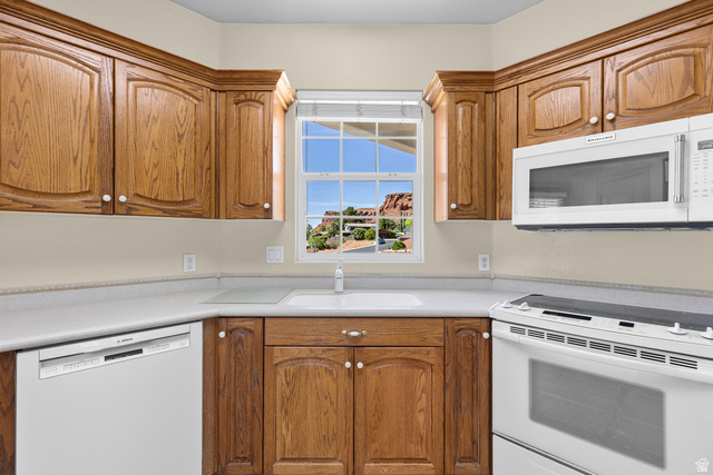389 North Main Street St. George, UT 84770 - Photo 24 of 44 Kitchen with white appliances, wood finish cabinets, and light countertops
