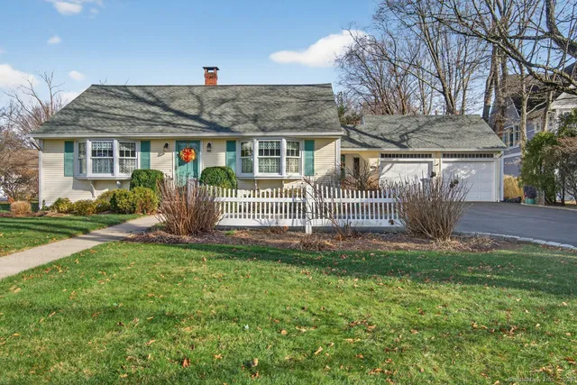 a front view of house with a garden
