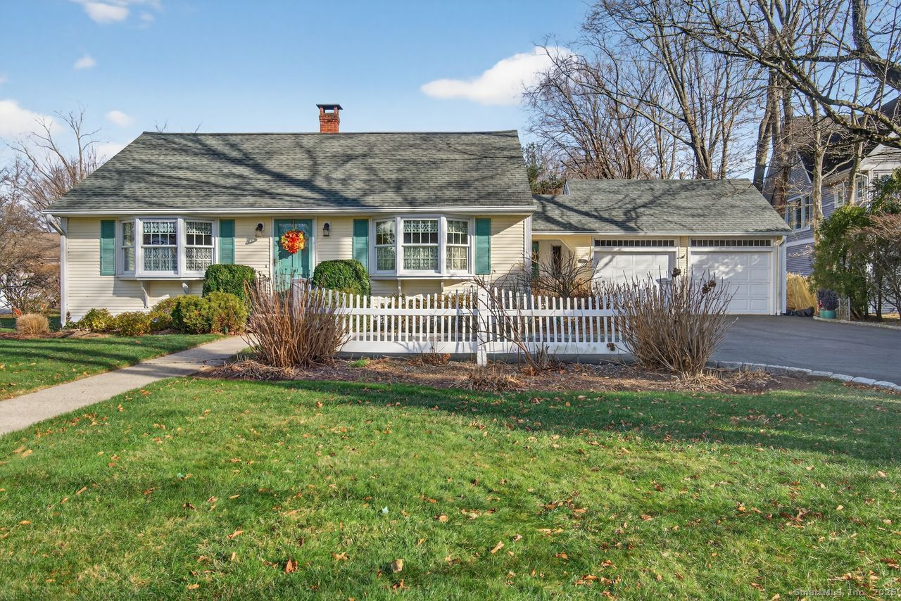 a front view of house with a garden