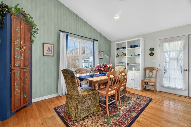 a dining room with furniture and wooden floor