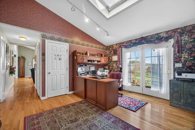a living room with stainless steel appliances granite countertop furniture and a rug