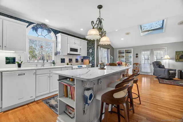 a large kitchen with a table and chairs in it