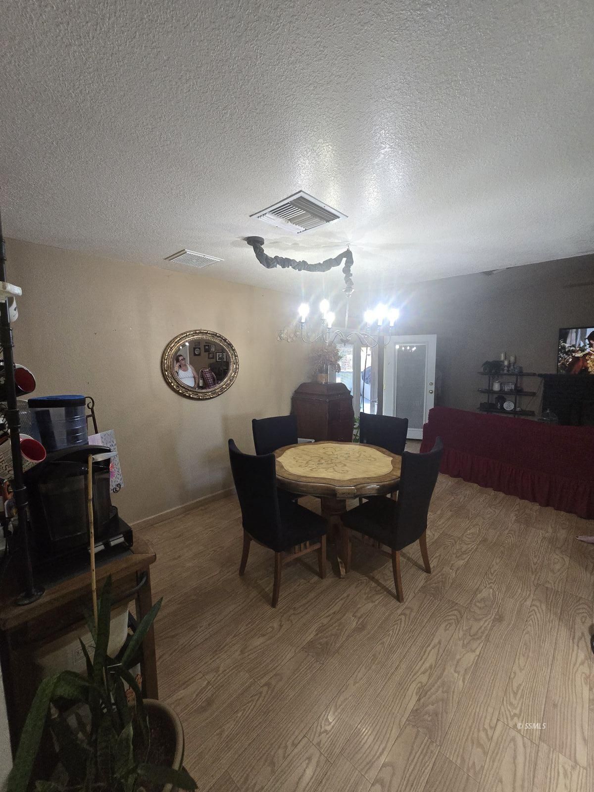201 East Benson Avenue Ridgecrest, CA 93555 - Photo 8 of 35 a living room with furniture and a chandelier