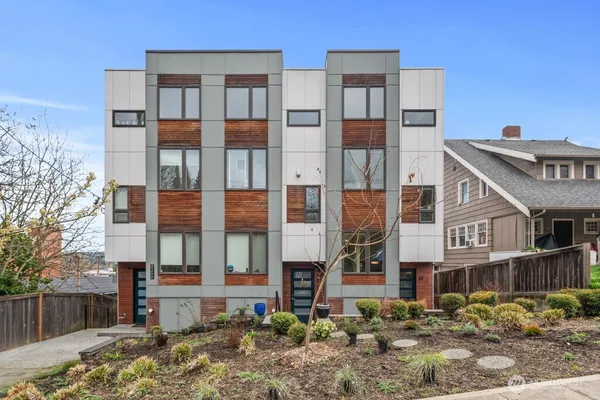 a front view of a residential apartment building with a yard