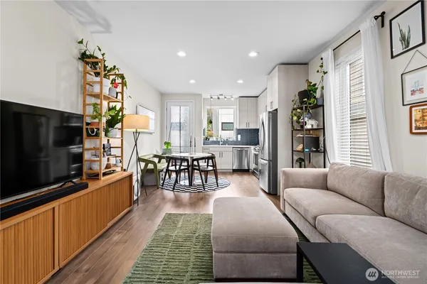 a living room with furniture and wooden floor
