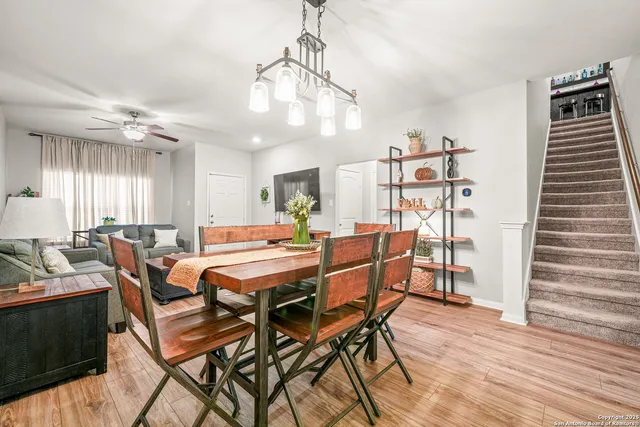 a dining room with a wooden table and chairs