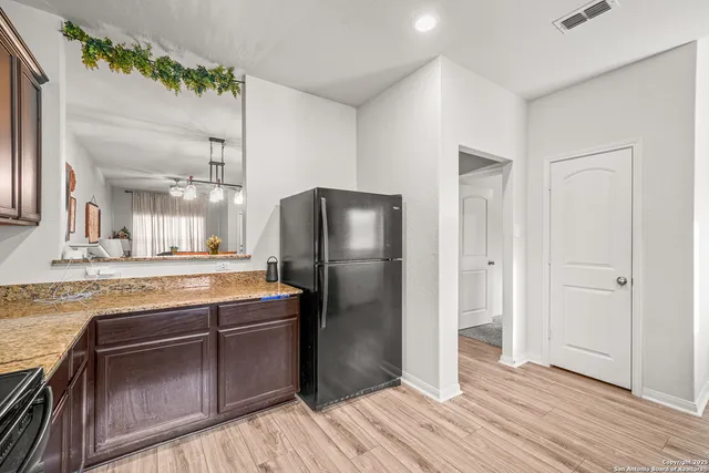 a kitchen with stainless steel appliances granite countertop a refrigerator and a sink