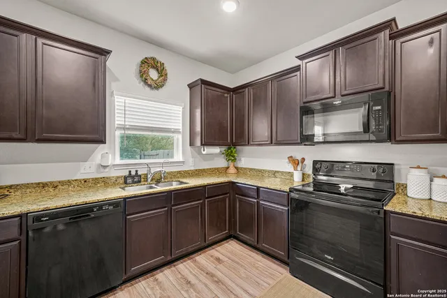a kitchen with a sink stove and microwave