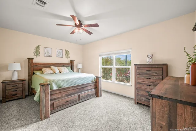 a bedroom with a bed dresser and a window