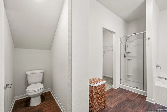 a bathroom with a toilet and a shower