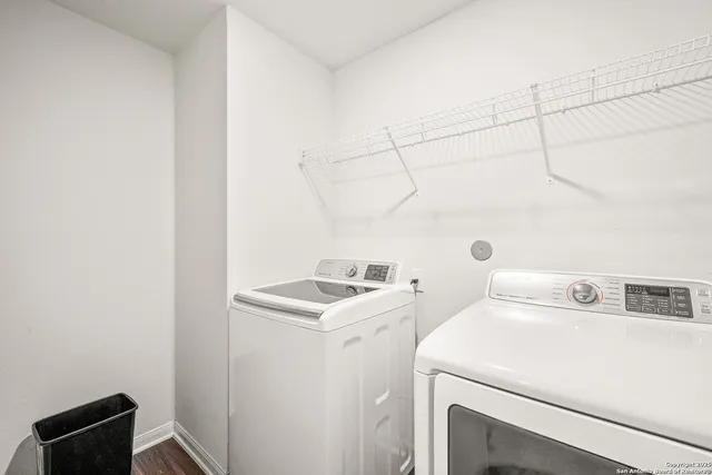 a bedroom with a bed potted plant with the dresser in front of it