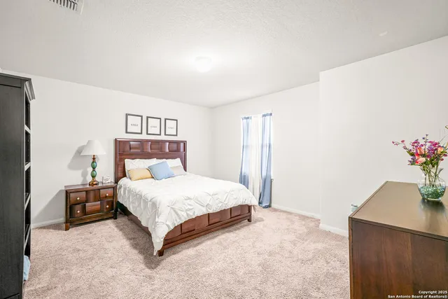 a living room with furniture and flowers