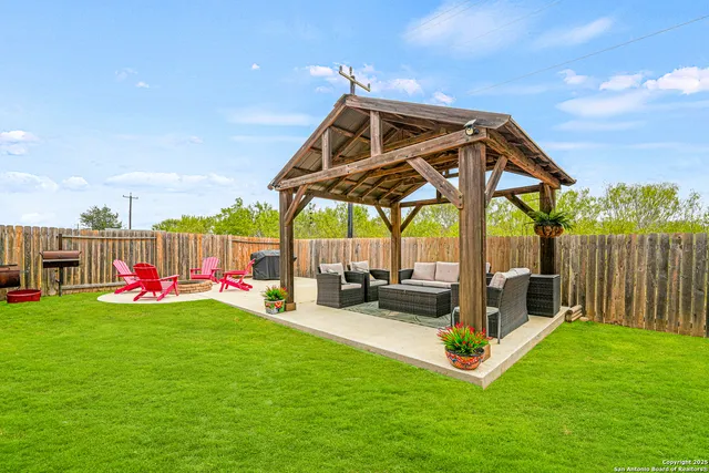 a backyard of a house with table and chairs