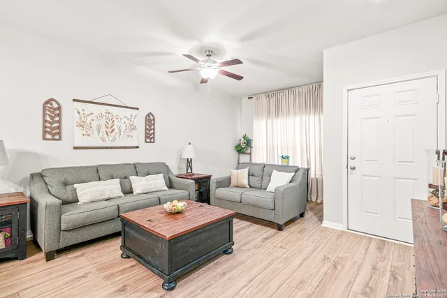 a living room with furniture and a wooden floor