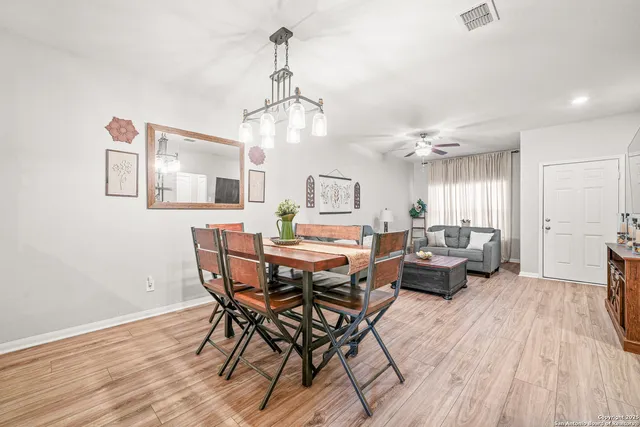 a view of a dining room with furniture wooden floor and chandelier