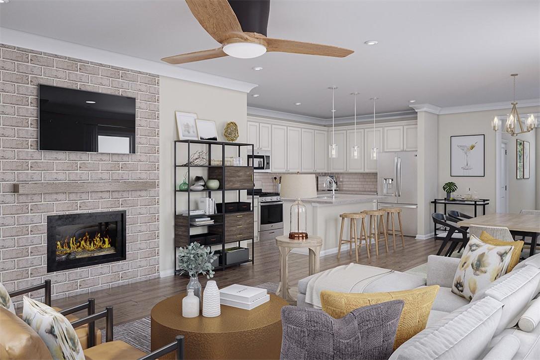 a living room with furniture kitchen view and a fireplace