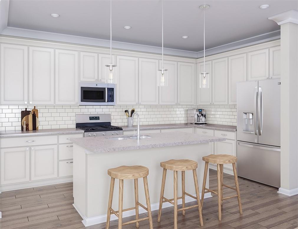 1026 Grays Ml Road Charlotte, NC 28215 - Photo 2 of 18 a kitchen with stainless steel appliances white cabinets and wooden floor