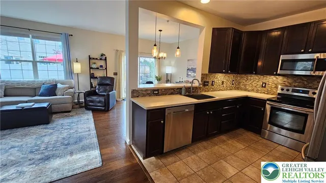 a kitchen with a sink stove and cabinets