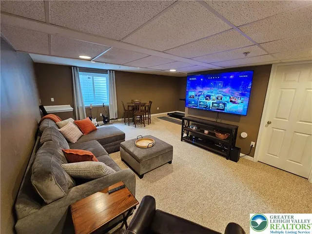 a projector room with furniture and a flat screen tv