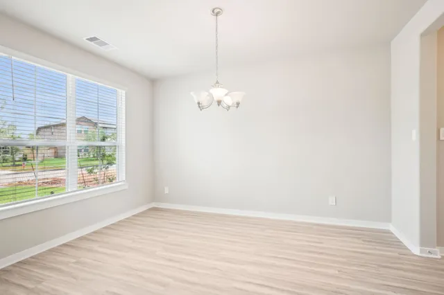 a view of a room with wooden floor and windows