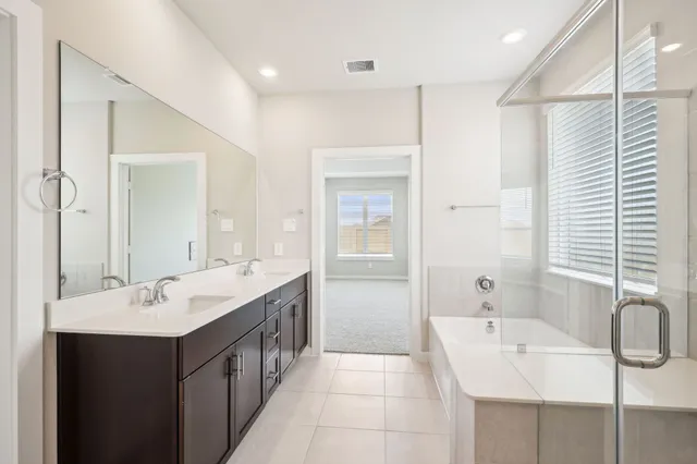 a bathroom with a double vanity sink mirror and