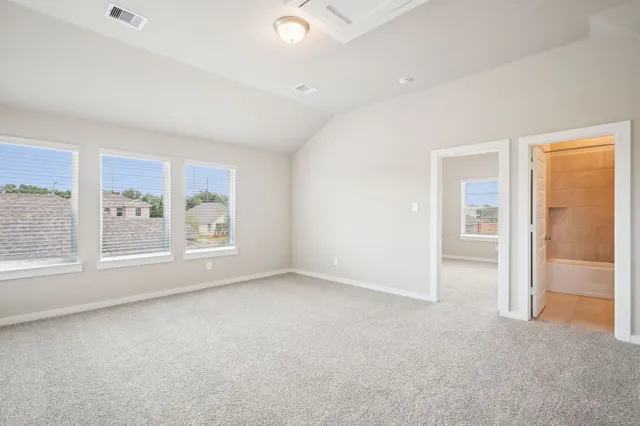 an empty room with windows and closet