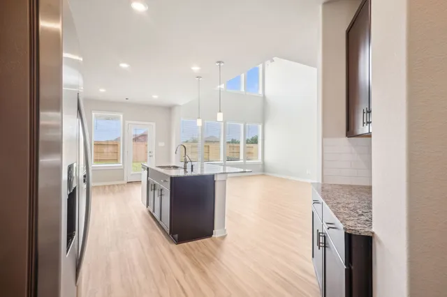 a kitchen with stainless steel appliances granite countertop a refrigerator and a sink