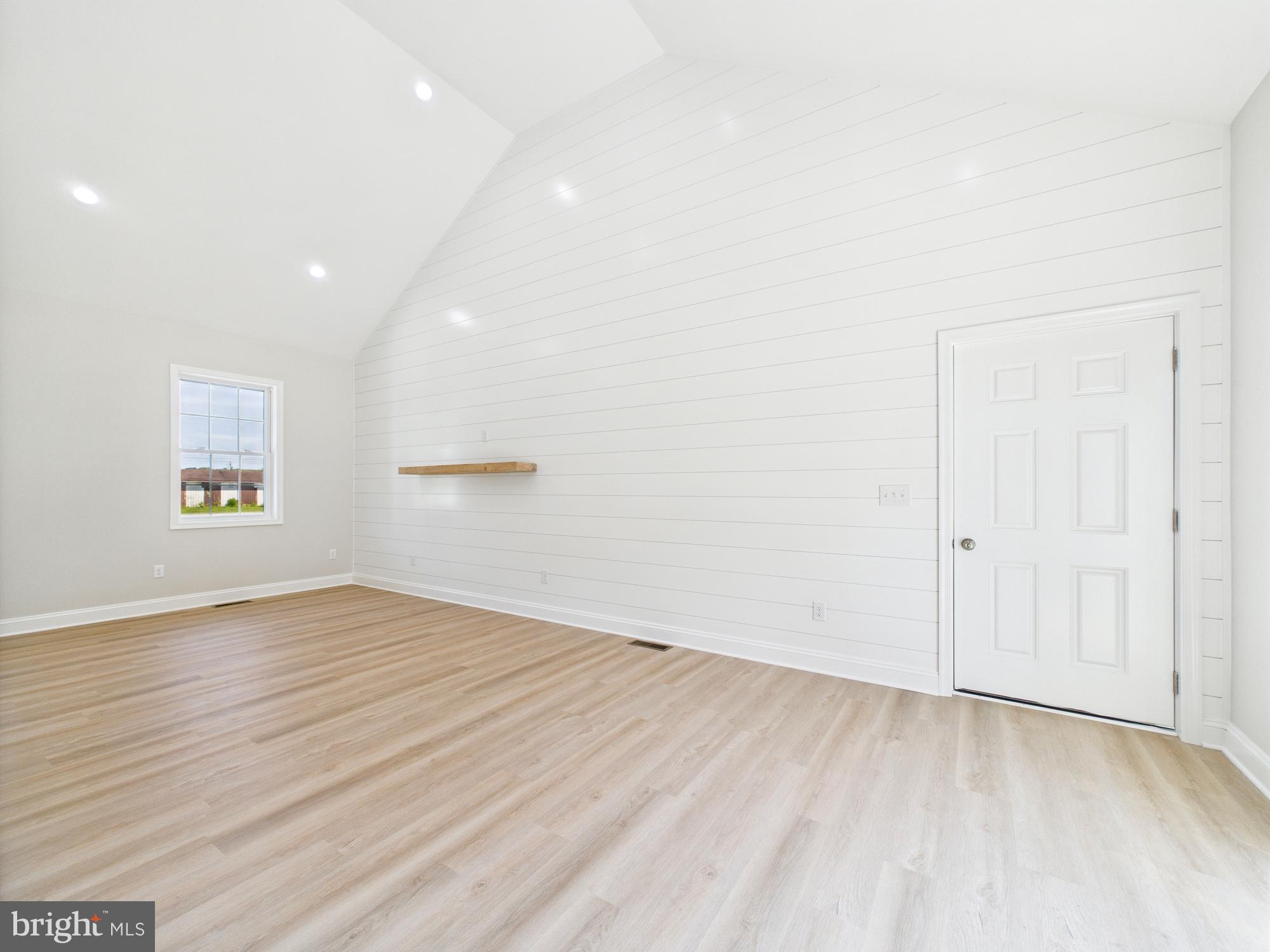 20168 Shingle Point Road Georgetown, DE 19947 - Photo 11 of 44 an empty room with wooden floor and windows