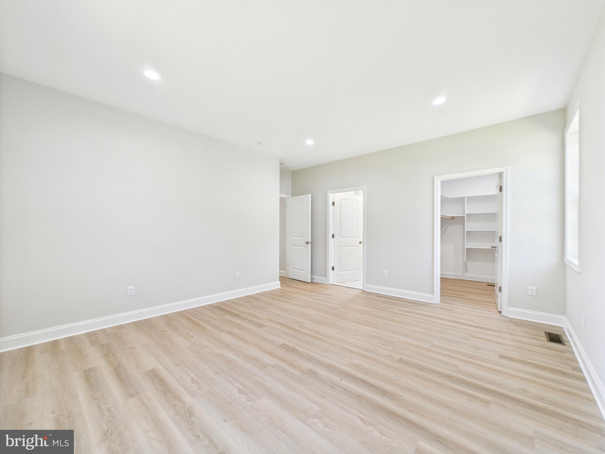 20168 Shingle Point Road Georgetown, DE 19947 - Photo 14 of 44 a view of an empty room with wooden floor and closet