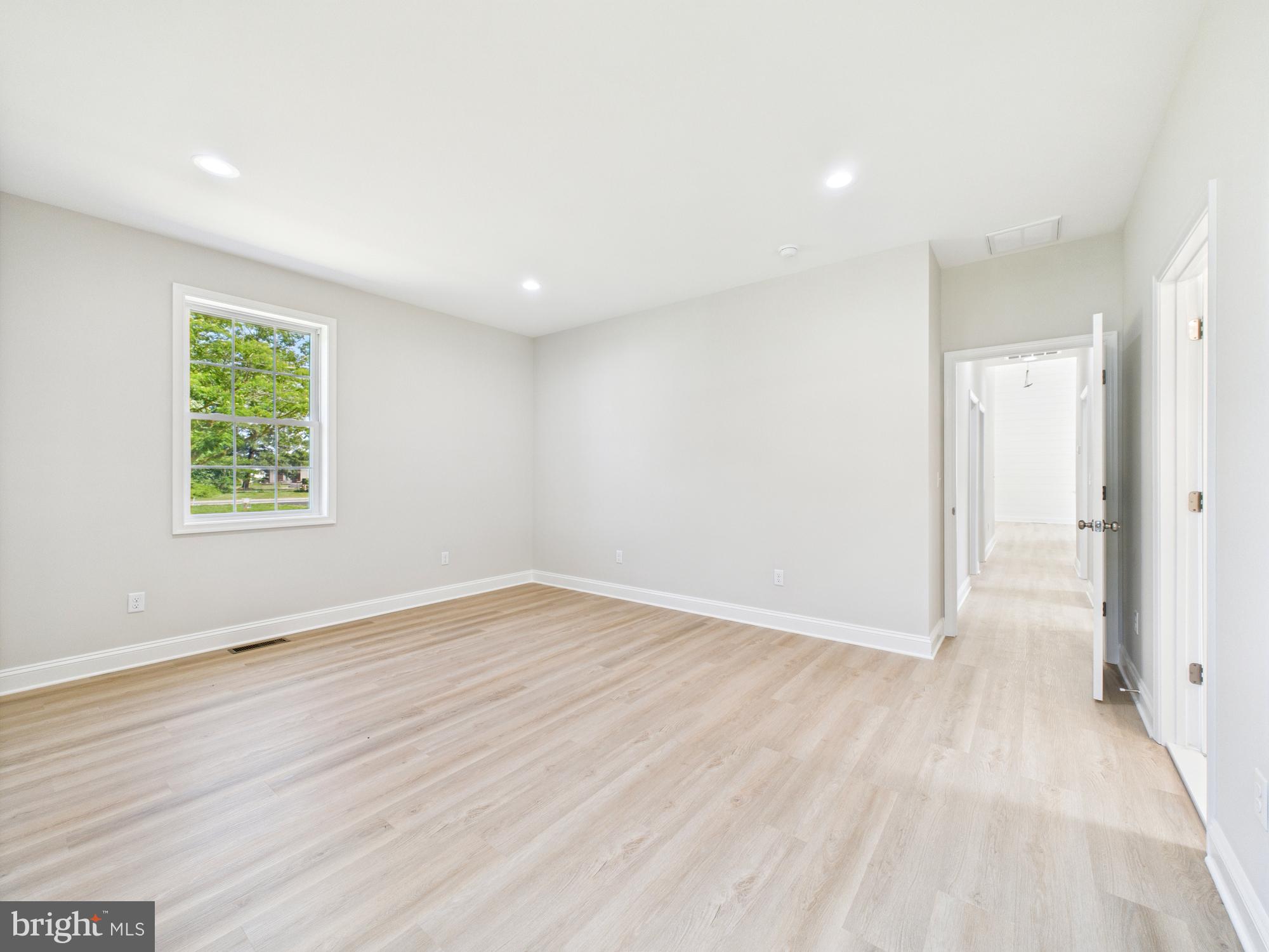 20168 Shingle Point Road Georgetown, DE 19947 - Photo 15 of 44 an empty room with wooden floor and a window