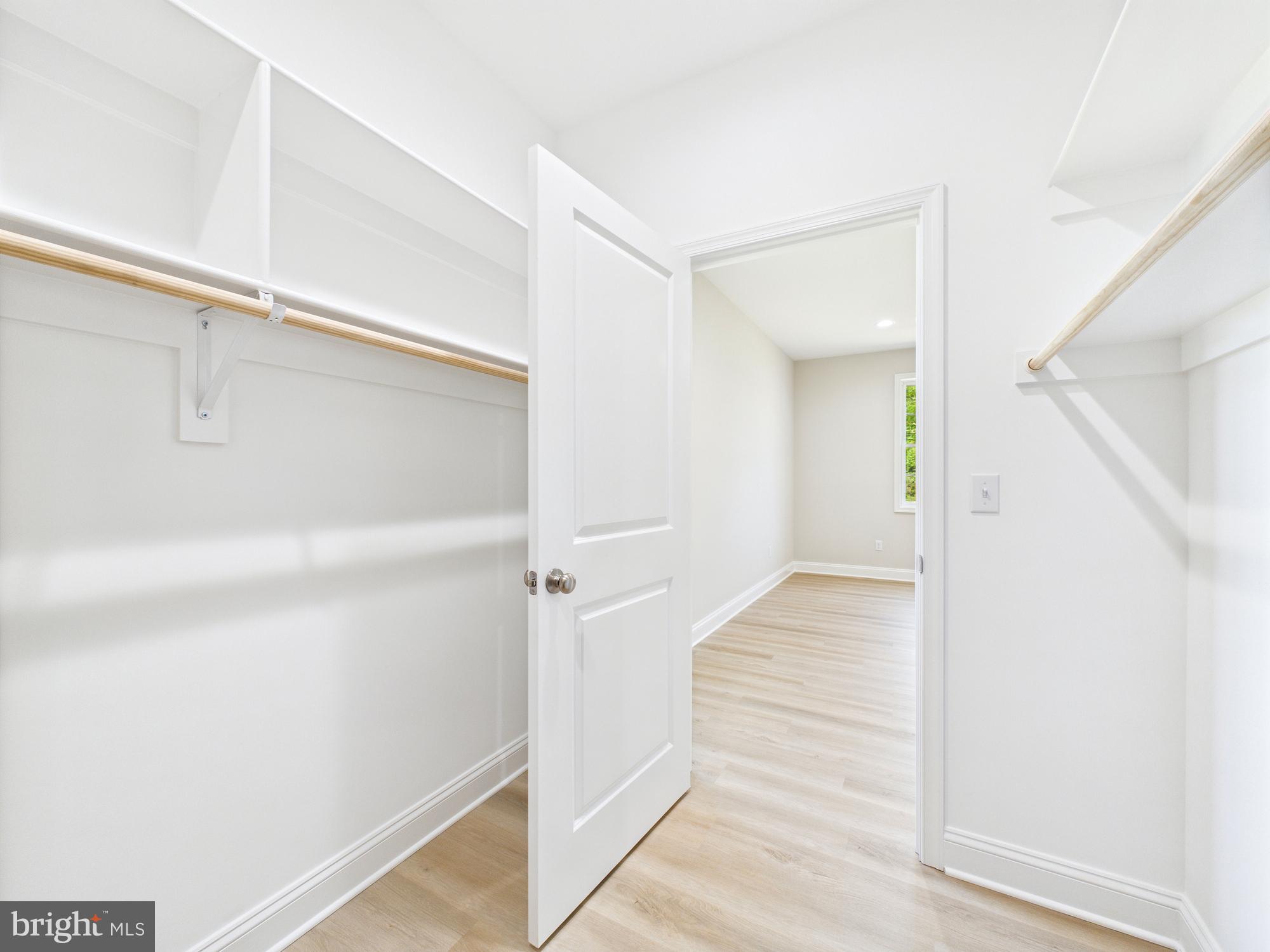 20168 Shingle Point Road Georgetown, DE 19947 - Photo 20 of 44 a view of a hallway with closet and wooden floor