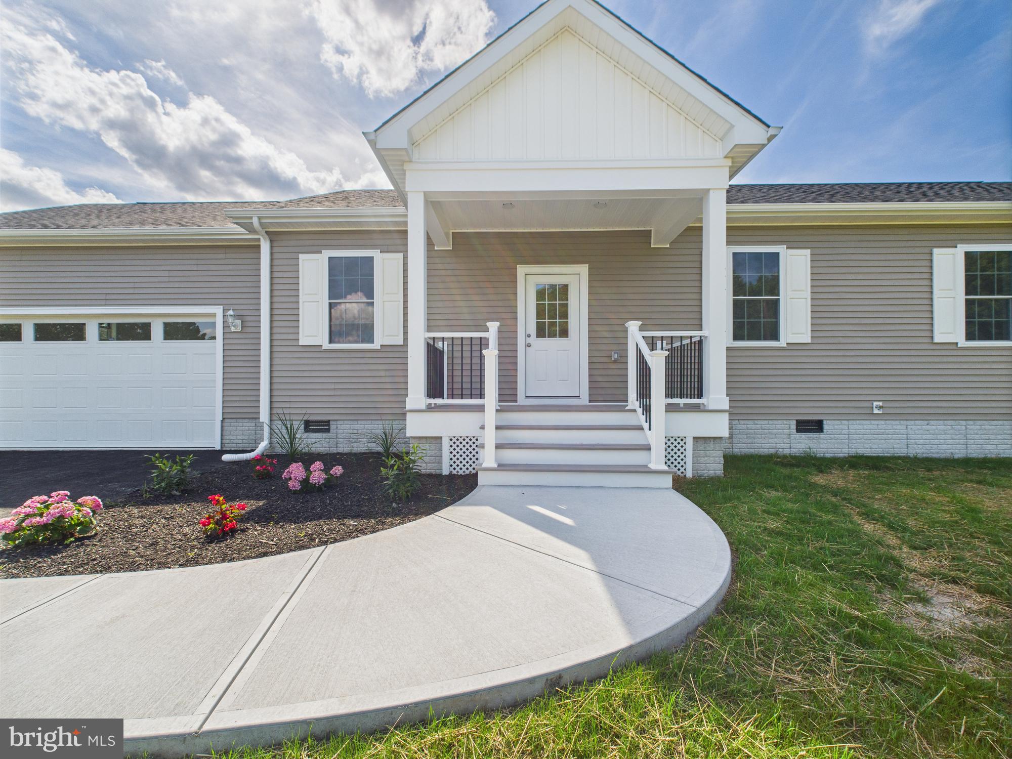 20168 Shingle Point Road Georgetown, DE 19947 - Photo 2 of 44 a front view of a house with a yard