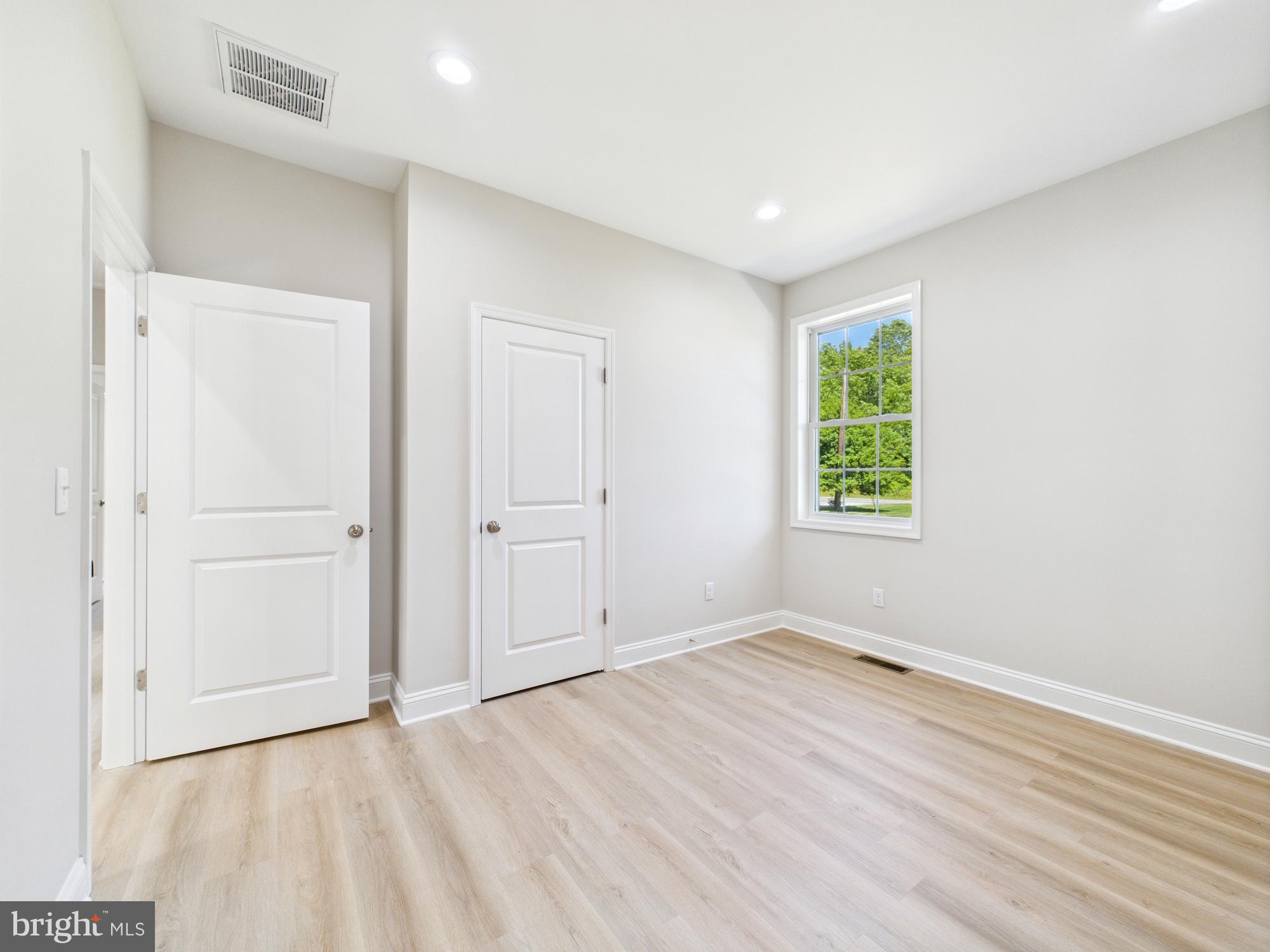 20168 Shingle Point Road Georgetown, DE 19947 - Photo 25 of 44 an empty room with windows and closet