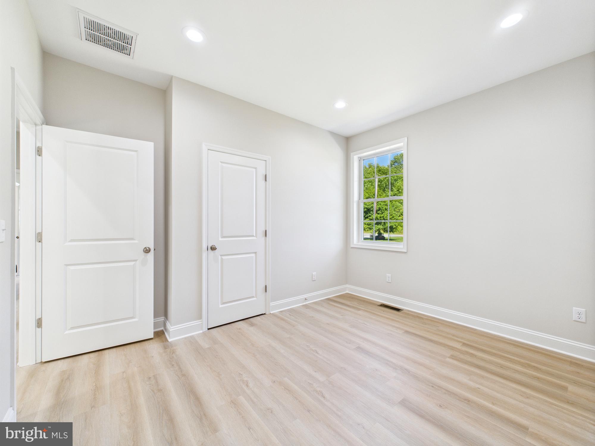 20168 Shingle Point Road Georgetown, DE 19947 - Photo 30 of 44 wooden floor in an empty room with a window